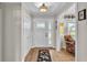 Inviting foyer with hardwood floors, a stylish light fixture, and a decorative front door at 860 Lila St, Bartow, FL 33830