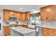 Kitchen with farmhouse sink, subway tile backsplash, wood cabinets, and stainless steel appliances at 860 Lila St, Bartow, FL 33830