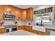 Bright kitchen with stainless steel appliances, white subway tile backsplash, and a farmhouse sink under the window at 860 Lila St, Bartow, FL 33830