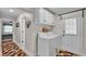 Utility room with washer and dryer, white cabinets, and a door leading to the outside at 860 Lila St, Bartow, FL 33830