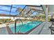 Sparkling pool surrounded by a screened enclosure with a ladder entry for safe and easy access at 860 Lila St, Bartow, FL 33830