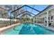 Inviting screened-in pool offers a relaxing retreat, perfect for enjoying sunny days and outdoor entertaining at 860 Lila St, Bartow, FL 33830