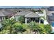 Backyard aerial view featuring a screened-in porch, lush greenery, and a fenced yard at 8718 Rindge Rd, Polk City, FL 33868