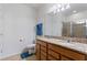 Bathroom with double sink vanity, granite countertop, and a glass-enclosed shower at 8718 Rindge Rd, Polk City, FL 33868