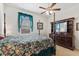 Cozy bedroom featuring a floral bedspread, ceiling fan, and matching wooden furniture at 8718 Rindge Rd, Polk City, FL 33868