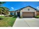 Charming single-story home with a well-manicured lawn and a two-car garage at 8718 Rindge Rd, Polk City, FL 33868