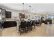 Open-concept kitchen with island, dark cabinetry, pendant lighting, and connected living space at 8718 Rindge Rd, Polk City, FL 33868