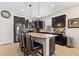 Stylish kitchen featuring granite countertops, an island with seating, and dark wood cabinets at 8718 Rindge Rd, Polk City, FL 33868