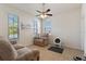 Cozy living room featuring neutral tones, plush seating, and an abundance of natural light from three windows at 8718 Rindge Rd, Polk City, FL 33868