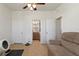 Well-lit living room showcasing ceramic tile flooring and access to the adjoining bathroom with a wooden vanity at 8718 Rindge Rd, Polk City, FL 33868