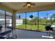 Screened-in porch with outdoor seating and a view of the serene, landscaped backyard at 8718 Rindge Rd, Polk City, FL 33868