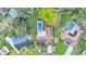 Overhead shot of a property boasting a screened pool, and mature landscaping in a quiet neighborhood at 1047 Sugartree S Ln, Lakeland, FL 33813