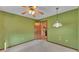 Bedroom with green walls, ceiling fan, and adjoining room at 1047 Sugartree S Ln, Lakeland, FL 33813