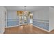 Dining area featuring hardwood floors, chandelier, and view to kitchen and backyard at 1047 Sugartree S Ln, Lakeland, FL 33813