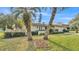 Beautifully landscaped front yard with palm trees framing this single-Gathering home at 1047 Sugartree S Ln, Lakeland, FL 33813