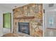 Stone fireplace with a wooden mantel, and adjacent doorways, adding character to the home at 1047 Sugartree S Ln, Lakeland, FL 33813