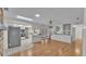 Open kitchen layout featuring granite countertops, skylights, and seamless access to the living space at 1047 Sugartree S Ln, Lakeland, FL 33813