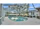 Clear, blue pool enclosed in a screened cage is set within a well-maintained backyard at 1047 Sugartree S Ln, Lakeland, FL 33813