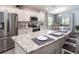 Stylish kitchen with white cabinets, stainless steel appliances, and a functional breakfast bar at 1108 Mountain Flower Ln, Davenport, FL 33837