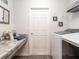 Bright laundry room features built-in marble countertop and modern washer and dryer at 1108 Mountain Flower Ln, Davenport, FL 33837