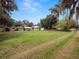 Backyard view showing the lot size with the house and a detached storage shed at 116 S Lanier Ave, Fort Meade, FL 33841