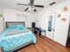 Bright bedroom with a ceiling fan and beautiful hardwood floors at 116 S Lanier Ave, Fort Meade, FL 33841