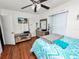 Cozy bedroom featuring hardwood floors and a modern entertainment center at 116 S Lanier Ave, Fort Meade, FL 33841