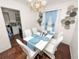 Elegant dining room with white table, chairs, chandelier, and decorative wall hangings at 116 S Lanier Ave, Fort Meade, FL 33841