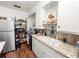 Cozy kitchen featuring white cabinets, granite countertops, and a mosaic backsplash at 116 S Lanier Ave, Fort Meade, FL 33841