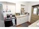 Functional kitchen featuring white cabinetry, stone countertops, and stainless steel appliances at 116 S Lanier Ave, Fort Meade, FL 33841