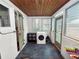 Enclosed laundry room featuring wood ceilings, a washing machine, and ample sunlight at 116 S Lanier Ave, Fort Meade, FL 33841