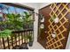 Outdoor balcony featuring an array of plants and decorative trellis with peaceful view at 141 Fernery Rd # C-6, Lakeland, FL 33809