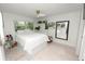 Bright bedroom with crisp white bedding, window views, and decorative shelving at 141 Fernery Rd # C-6, Lakeland, FL 33809