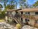 Attractive condominium building with stairways leading to cozy balconies, surrounded by greenery at 141 Fernery Rd # C-6, Lakeland, FL 33809