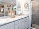 Bright bathroom with a double sink vanity, marble countertop, and a glass-enclosed shower at 1412 Fleur Dr, Davenport, FL 33837