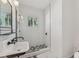 Modern bathroom with white subway tile, black fixtures, and patterned floor at 1539 E Fern Rd, Lakeland, FL 33801