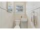 Cozy powder room with decorative walls, a sleek sink, modern fixtures, and natural light at 1539 E Fern Rd, Lakeland, FL 33801