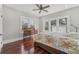 Bright bedroom featuring hardwood floors, ceiling fan, natural light and antique dresser at 1539 E Fern Rd, Lakeland, FL 33801