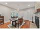 Charming dining room featuring hardwood floors, stone fireplace and a rustic dining table set at 1539 E Fern Rd, Lakeland, FL 33801