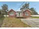 Charming brick home features a wood porch, green front door, and a well-maintained front yard at 1539 E Fern Rd, Lakeland, FL 33801