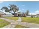 A charming, single-story brick home features a well-manicured lawn and a bright green front door at 1539 E Fern Rd, Lakeland, FL 33801