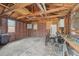 Garage interior with exposed brick, exposed wood rafters, concrete floor and two bicycles at 1539 E Fern Rd, Lakeland, FL 33801