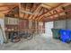 Garage interior with exposed brick, exposed wood rafters, concrete floor and two bicycles at 1539 E Fern Rd, Lakeland, FL 33801