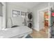 Bright laundry room with stacked washer and dryer, window, table and a doorway to another room at 1539 E Fern Rd, Lakeland, FL 33801