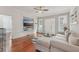 Bright living room featuring hardwood floors, a comfortable sectional, and ample natural light at 1539 E Fern Rd, Lakeland, FL 33801