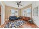 Cozy living room featuring hardwood floors, a comfortable blue sofa, and natural light at 1539 E Fern Rd, Lakeland, FL 33801