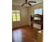 Bedroom featuring wood-look flooring, a large window, and a headboard at 1560 Imperial Ave, Bartow, FL 33830