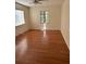 Spacious bedroom featuring laminate flooring, a window for natural light, and neutral walls at 1560 Imperial Ave, Bartow, FL 33830