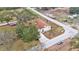 An aerial view of a well-maintained home with a spacious yard and surrounding neighborhood at 1702 Valencia Blvd, Bartow, FL 33830