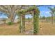 Arched entrance to backyard with lush greenery at 1702 Valencia Blvd, Bartow, FL 33830